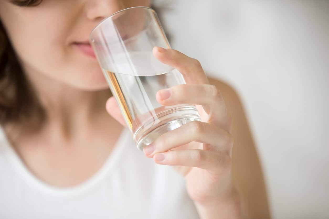 Woman drinking glass of water.