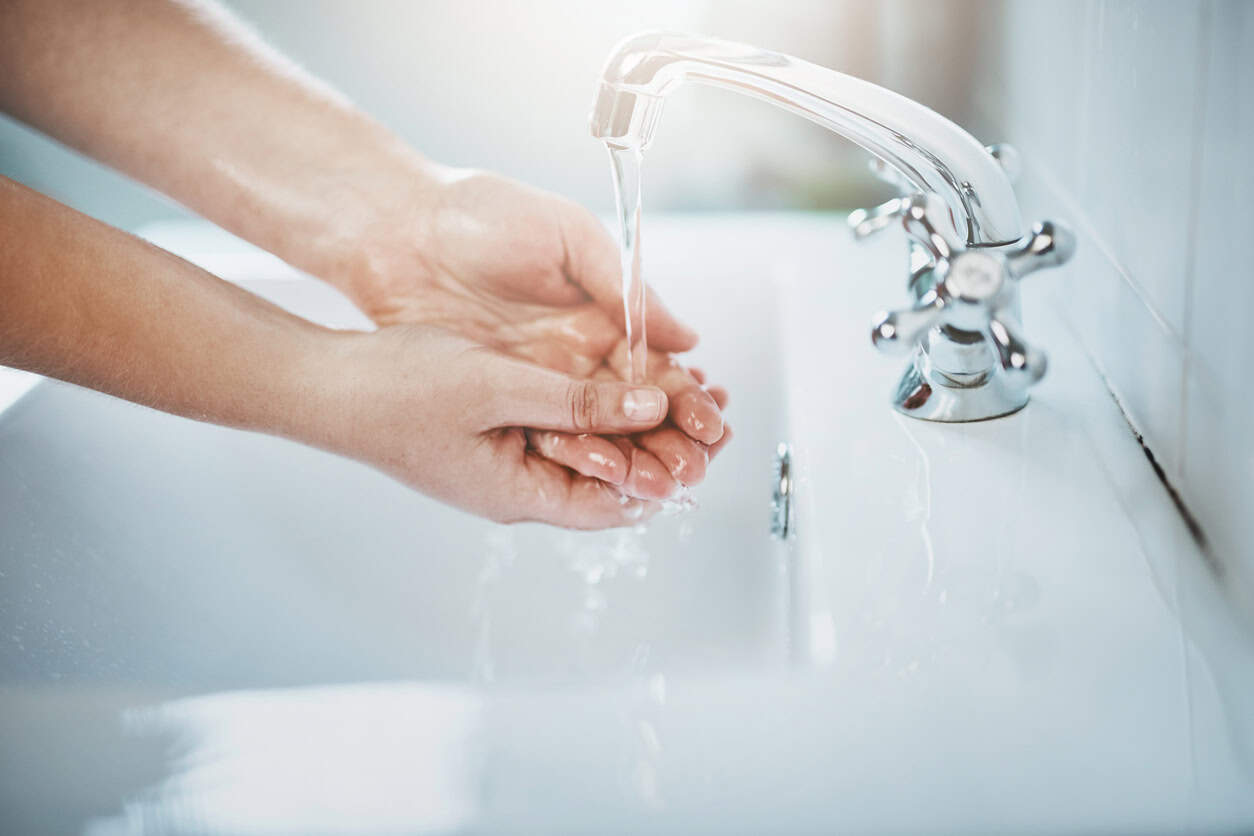 Side view of a person washing their hands
