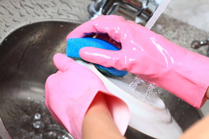 Young woman washing dishes in the kitchen.