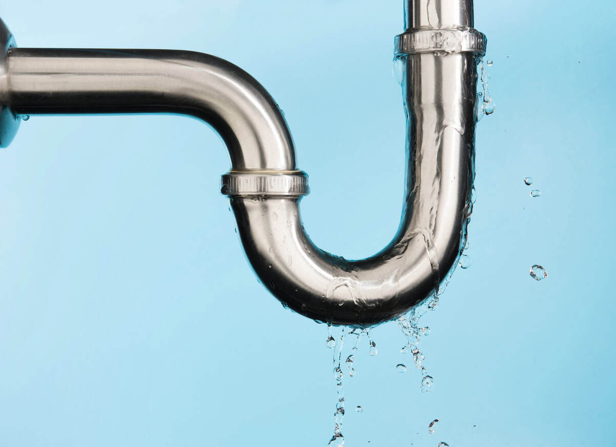 Leaking of water from stainless steel sink pipe on isolated on light blue background
