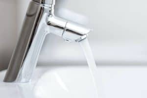 Modern bathroom faucet with flowing water