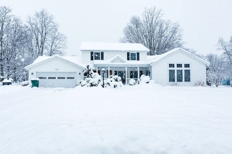 Suburban Colonial Home During Extreme Blizzard Snowstorm