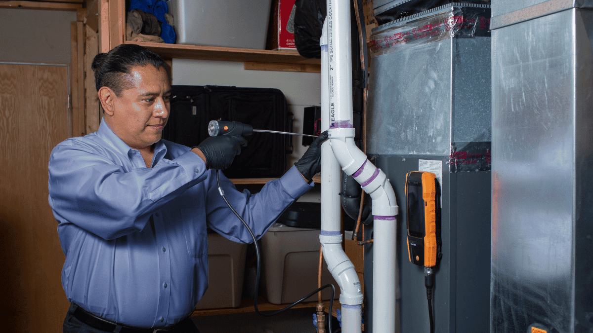 Worker performing a furnace tuneup