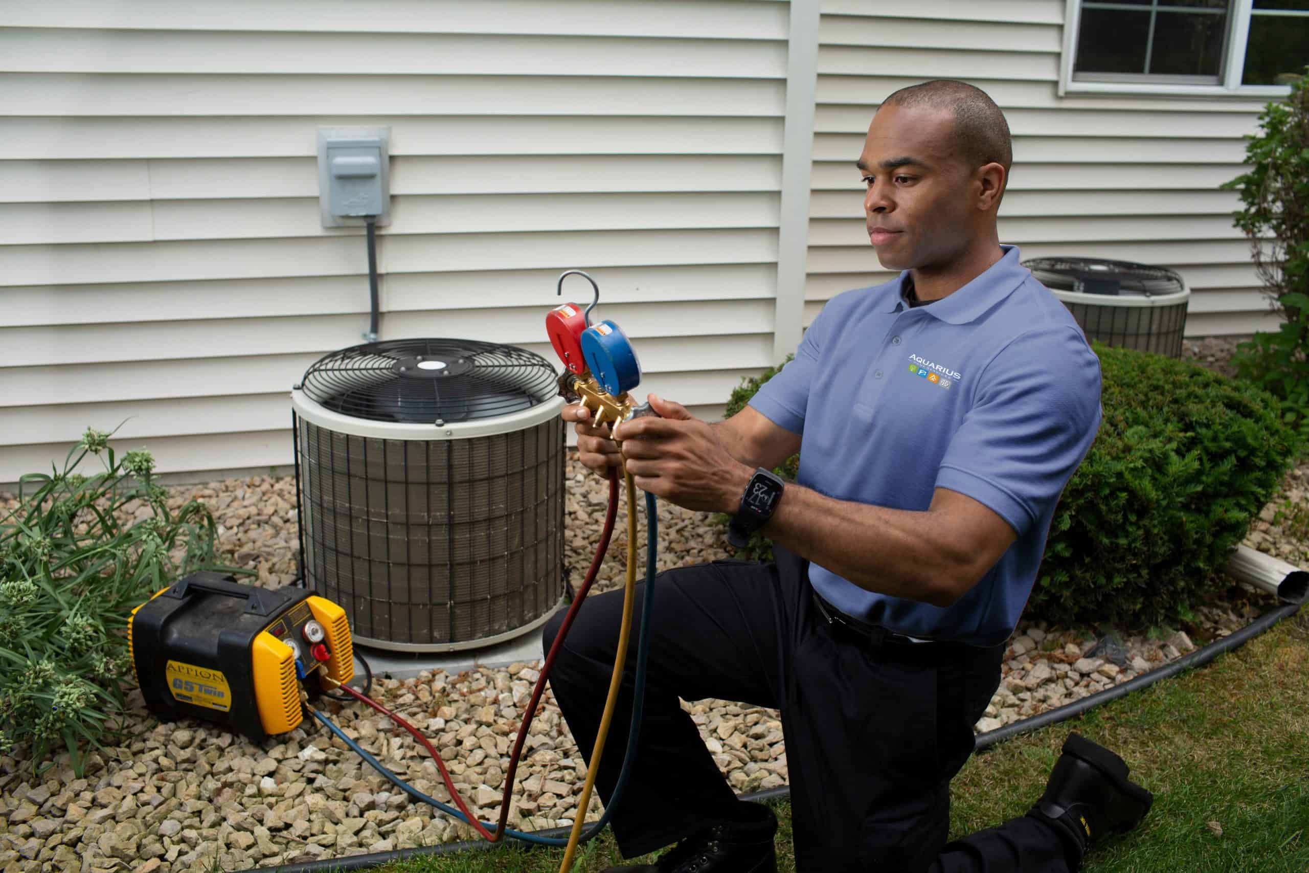 Technician inspecting air conditioner