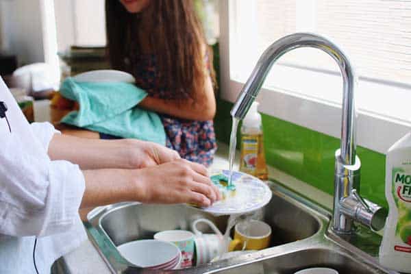 closeup of woman washing dishes