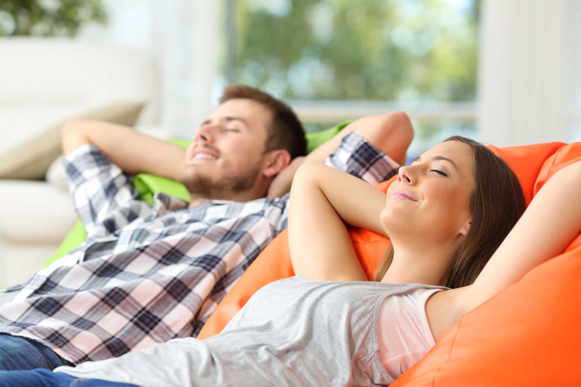 couple relaxing in air conditioned living room