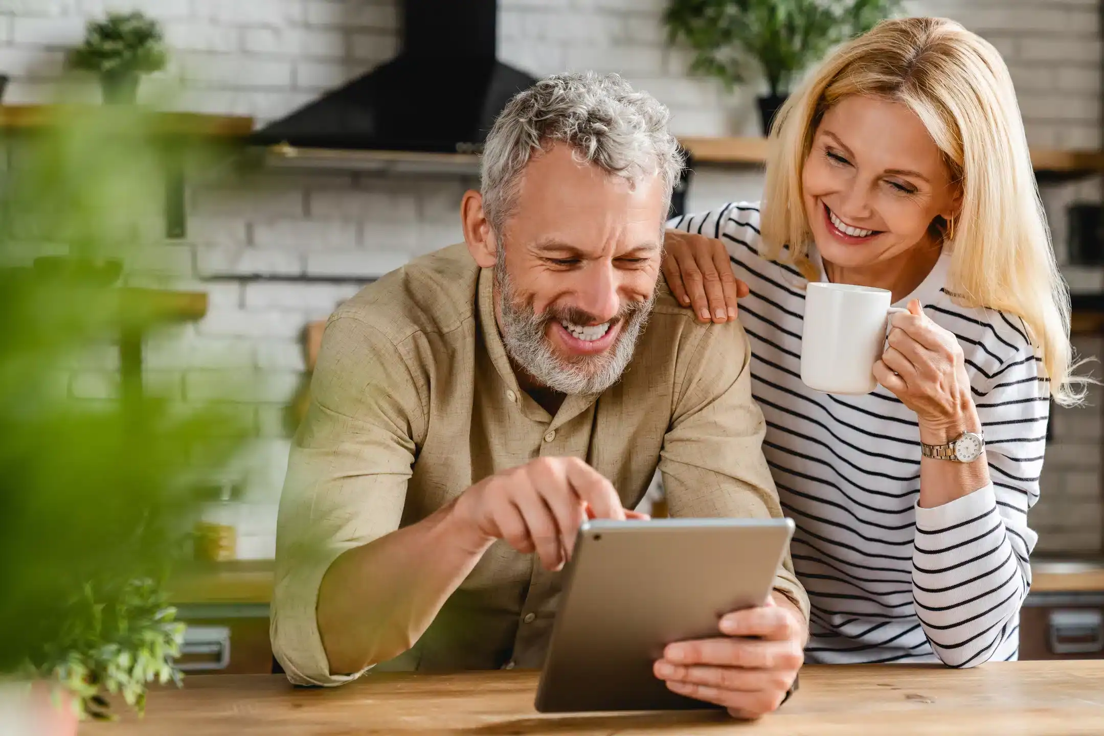couple with coffee and tablet