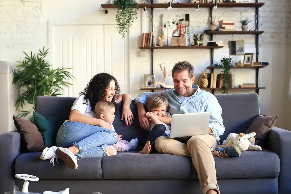 A family of 4 cuddling on the couch