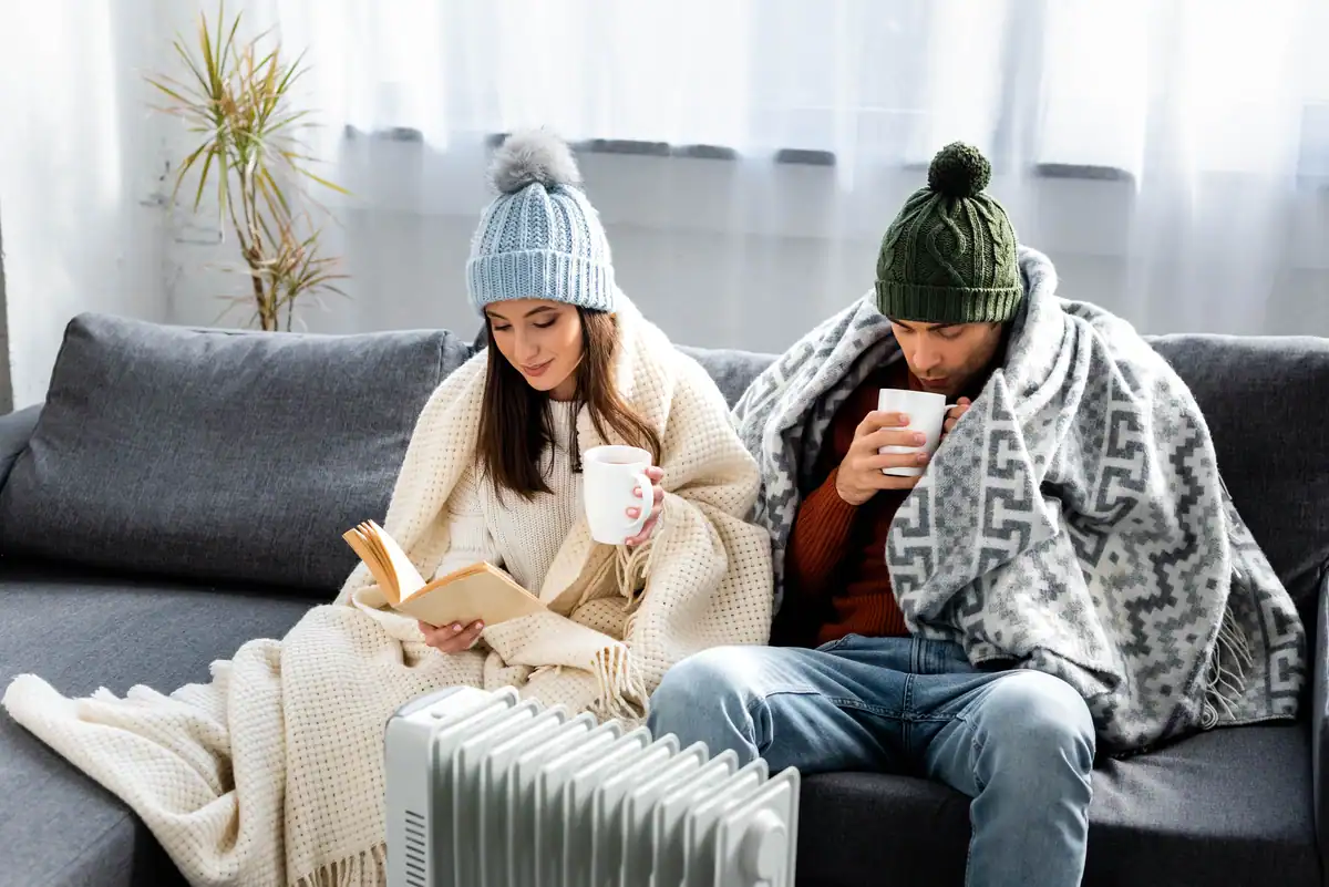 how to save on heating bill-couple at home with heater