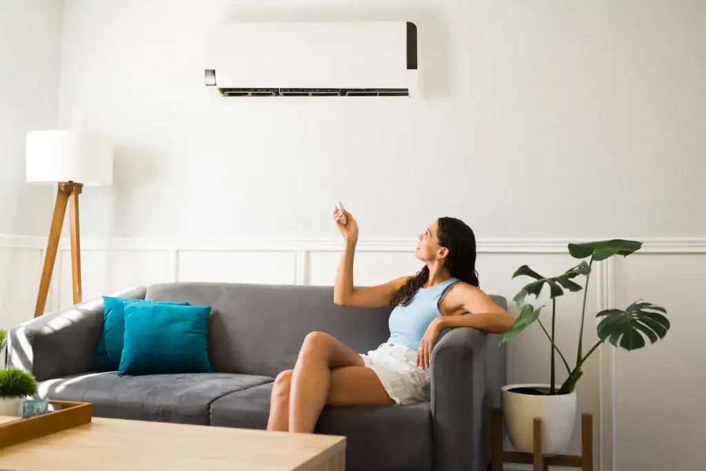 homeowner using her air conditioner after a fresh repair
