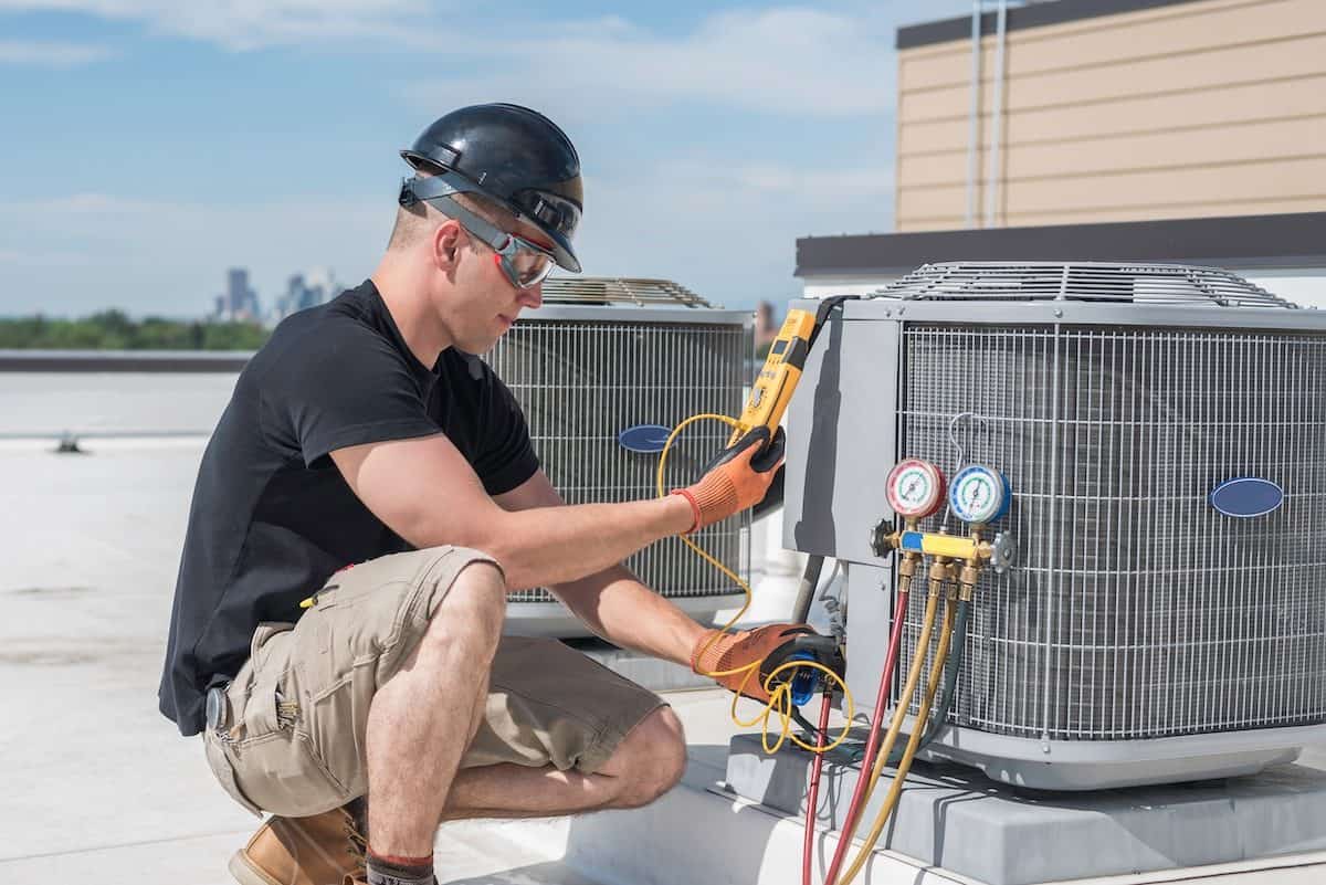 Hvac Tech Looking At A Multimeter