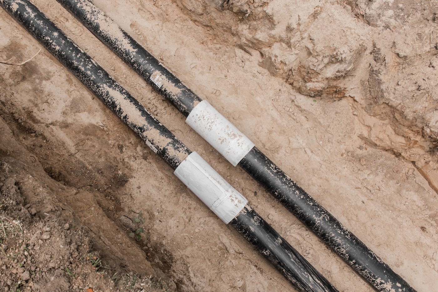 Repair Of The Water Line Of The Heating Main Pipe In The Ground Trench Pipeline At The Construction Site Work Industry