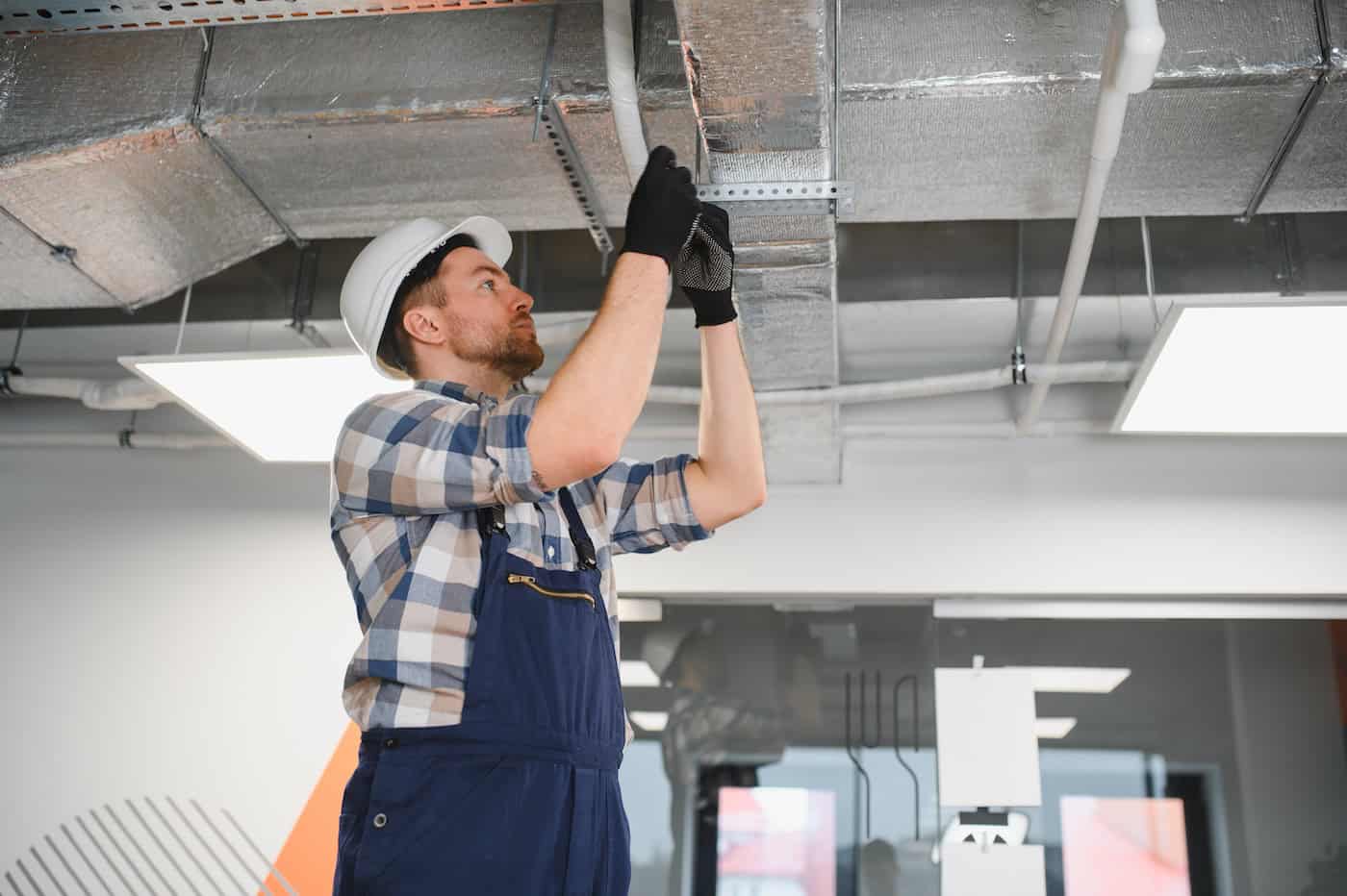 Hvac Technician Installing Air Conditioning Ventilation System