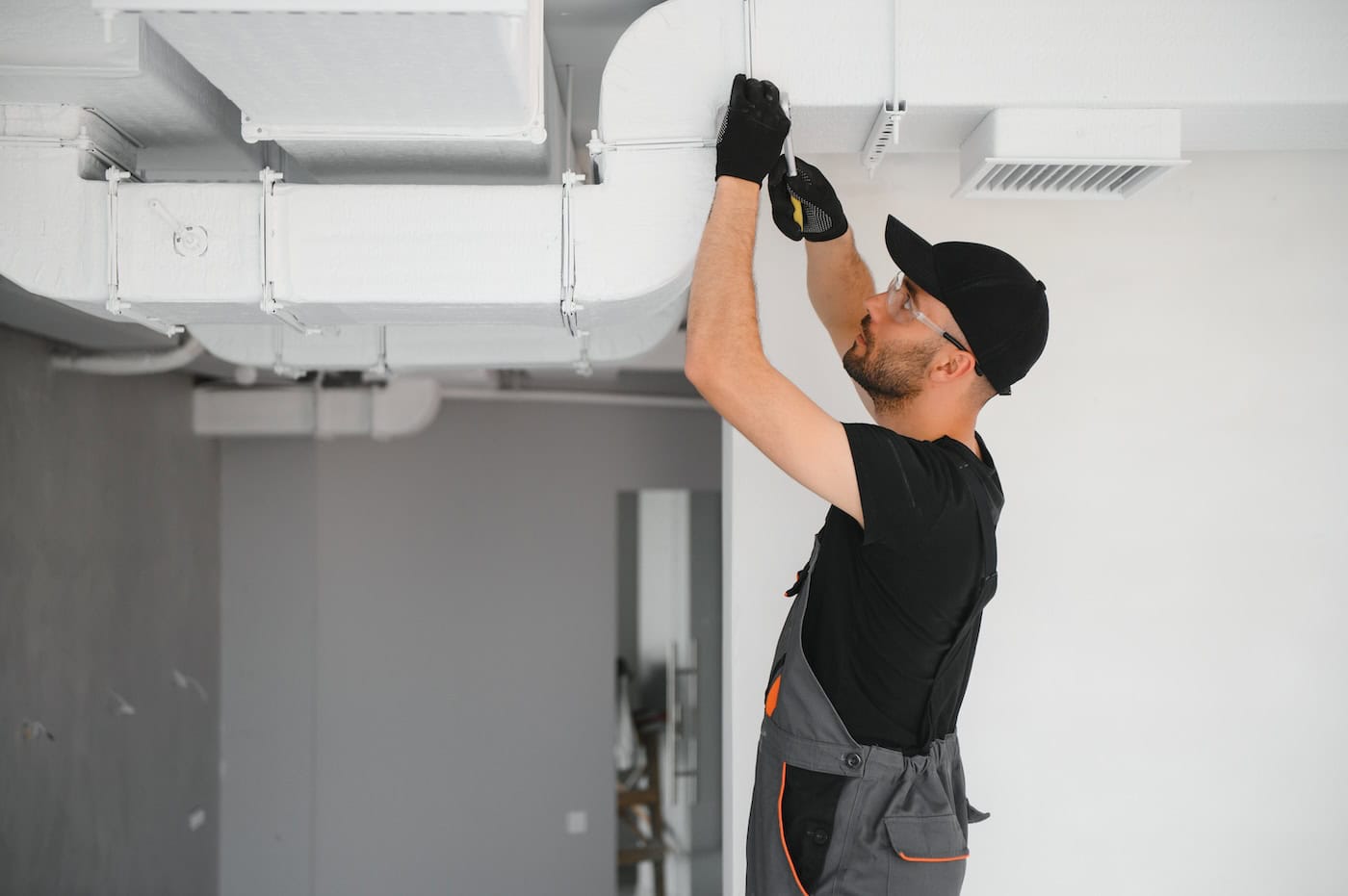 Hvac Technician At Work. Ventilation, Heating System Maintenance And Repair