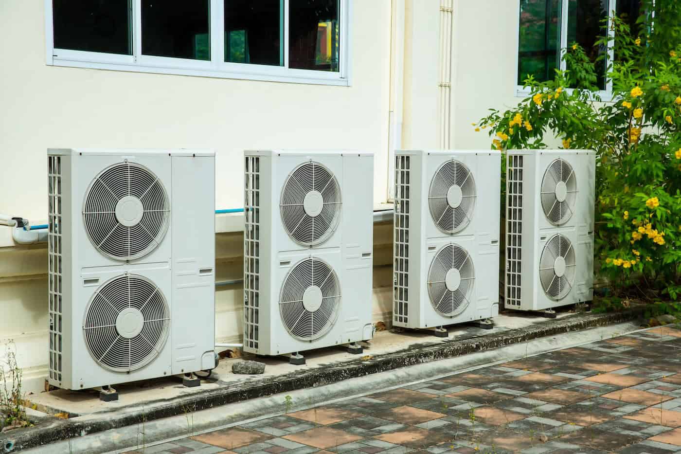 Air Conditioner Compressor Installed In Old Building. Outdoor Split Wall Type Air Conditioner Compressor Unit Inverter Installed On The Outside Of The Building. Air Conditioner Compressor Outdoor Unit