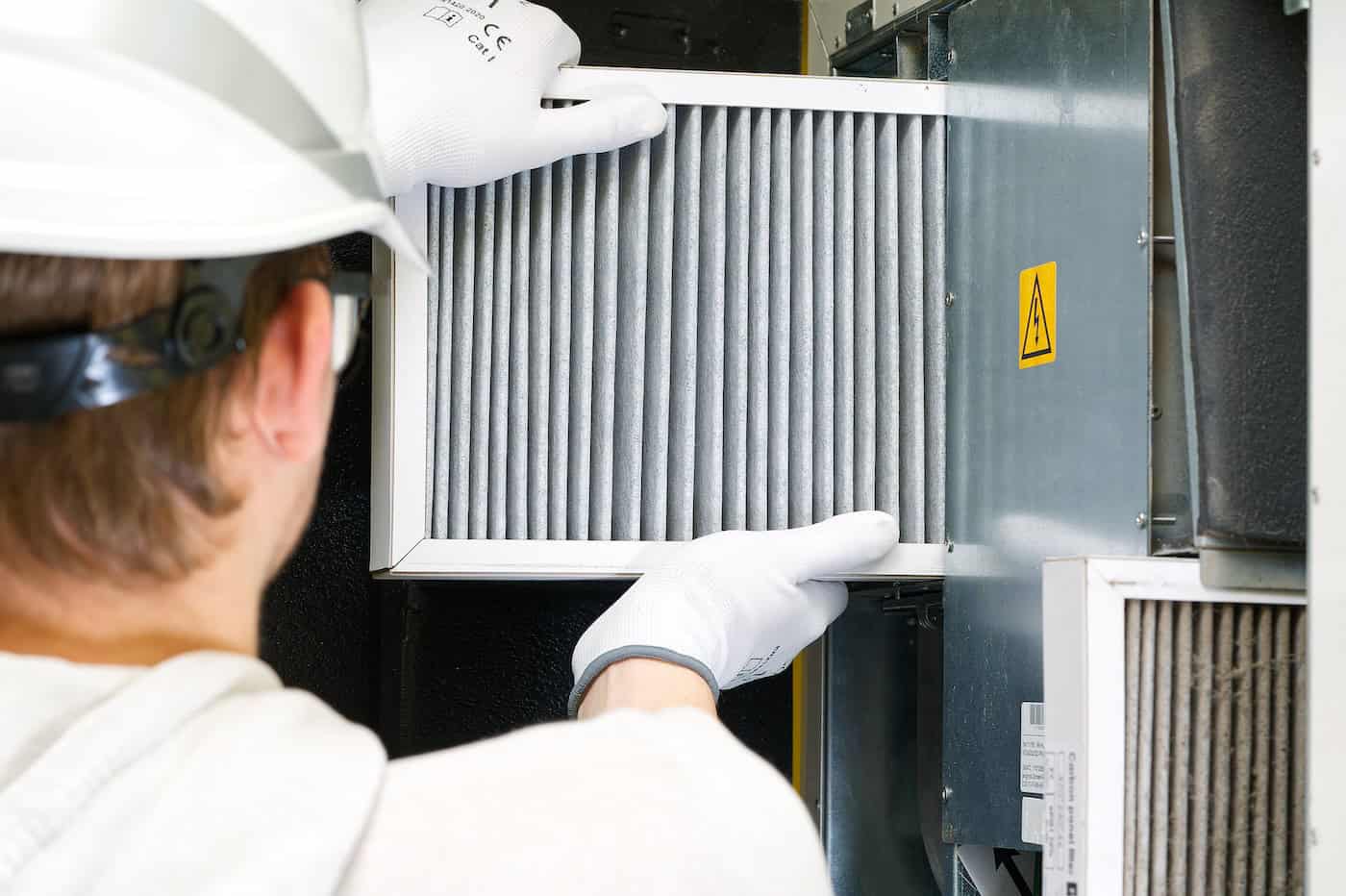 Hvac Filter Replacement Home Central Air System. Servicemen Changing Filter In Furnace.