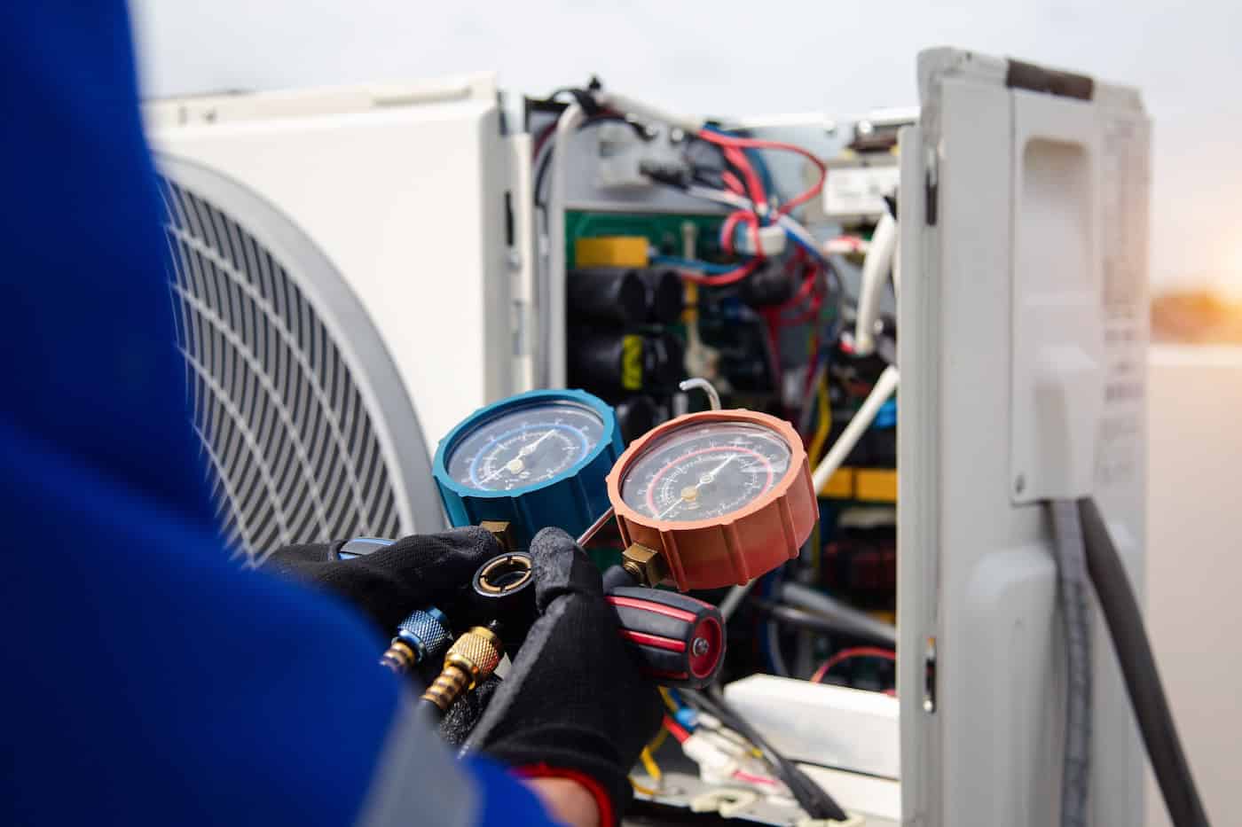 Air Conditioner Service .the Air Conditioner Technician Is Using A Gauge To Measure The Refrigerant Pressure. Air Compressor.