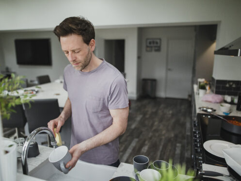 man washing dishes