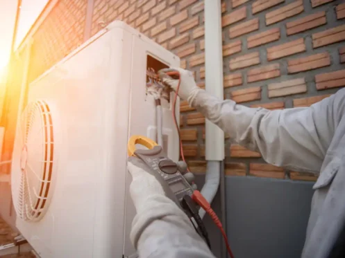 Technician repairing a heat pump